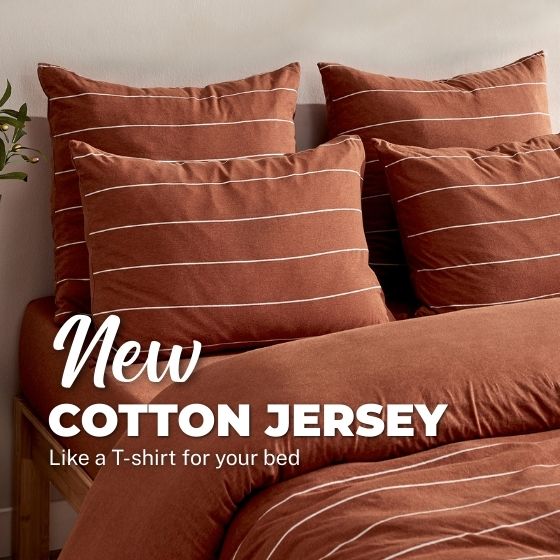 Rust terracotta striped bedding set with pillows on a bed, New Cotton Jersey.